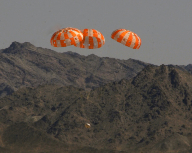 NASA successfully tested the parachute system of its Orion spacecraft at the U.S. Army Proving Ground in Arizona on June 25, 2014.  A test version of the spacecraft is shown here descending to the ground under its three main parachutes.  The space agency said this was the most difficult test of the spacecraft’s parachute system as it is getting set for Orion’s first trip into space in December 2014. (NASA) 
