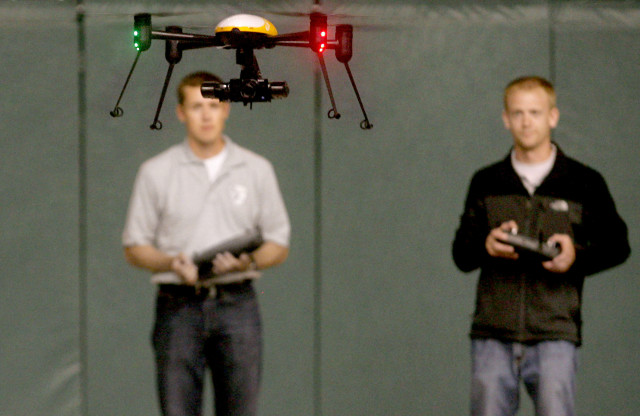 Representatives from the John D. Odegard School of Aerospace Sciences at the University Of North Dakota, Grand Forks, are shown here piloting a Draganflyer X4ES drone during a demonstration on Tuesday, June 24, 2014.  They were demonstrating the drone’s possible use in various law enforcement applications. (AP)