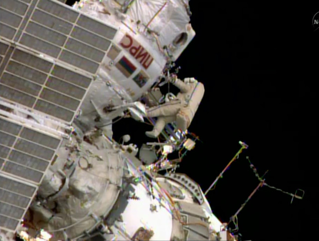 Oleg Artemiev, a member of the International Space Station crew is shown here floating outside the ISS as he and his fellow crewmember Alexander Skvortsov took a walk in space on June 19, 2014.  During their space-walk or extra-vehicular activity (EVA), the two Russian astronauts installed a new antenna, moved a cargo boom and did some other work that could only be done from outside the space station (NASA)