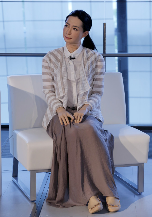 Otonaroid, a female-announcer robot is shown here addressing a crowd during a press event at the National Museum of Emerging Science and Innovation Miraikan in Tokyo Tuesday, June 24, 2014. Android expert Hiroshi Ishiguro, who created Otonaroid, also demonstrated others that included another girl robot called Kodomoroid and a bald-headed mannequin robot with pointed arms called Telenoid. (AP)