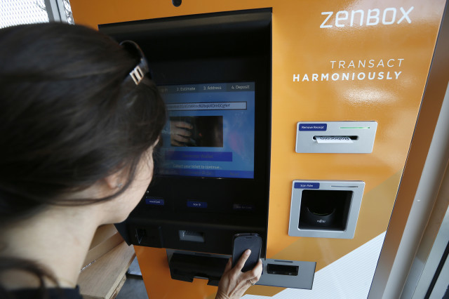 A customer in Santa Monica, California uses one of two new ATM’s that were put into operation June 21, 2014 in Southern California to purchase the popular digital currency, bitcoins. (Reuters)