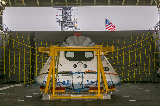 NASA, along with Lockheed Martin Corporation and the US Navy will soon be conducting recovery tests in the Pacific Ocean that will simulate the return of the new Orion spacecraft from a space mission.  Here an Orion “test vehicle” is shown sitting in the well deck of the USS Anchorage at the Port of Los Angeles on Wednesday, Aug. 6, 2014. (AP)