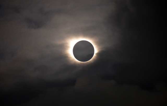 A total solar eclipse is visible through the clouds as seen from Vagar on the Faeroe Islands on 3/30/15.  The Faeroe Islands is an archipelago located halfway between Norway and Iceland. (AP)