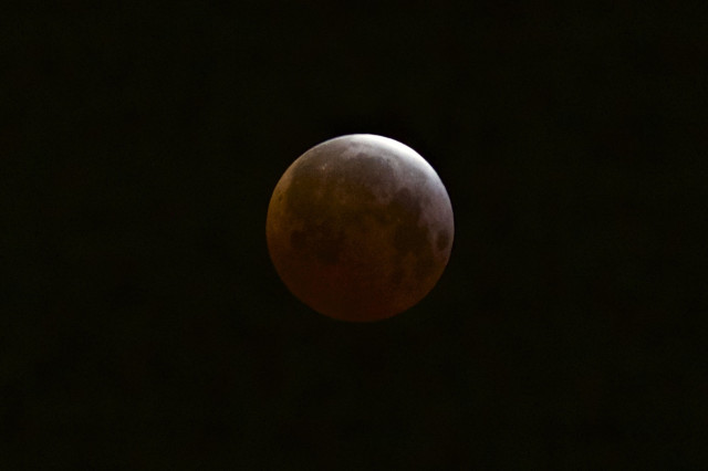 Here’s a view of the shortest lunar eclipse of the century as seen from the Echo Park district of Los Angeles on 4/4/15.  (AP)