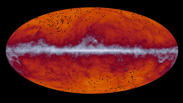 Researchers in a study released on 3/13/15 have successfully identified what they are calling a "treasure chest" of ancient galaxy clusters. This map of the entire sky was captured by the European Space Agency's Planck mission. The band running through the middle corresponds to dust in our Milky Way galaxy. The black dots indicate the location of galaxy cluster candidates identified by Planck and subsequently observed by the European Space Agency's Herschel mission.  (ESA/Planck Collaboration/ H. Dole, D. Guéry & G. Hurier, IAS/University Paris-Sud/CNRS/CNES)