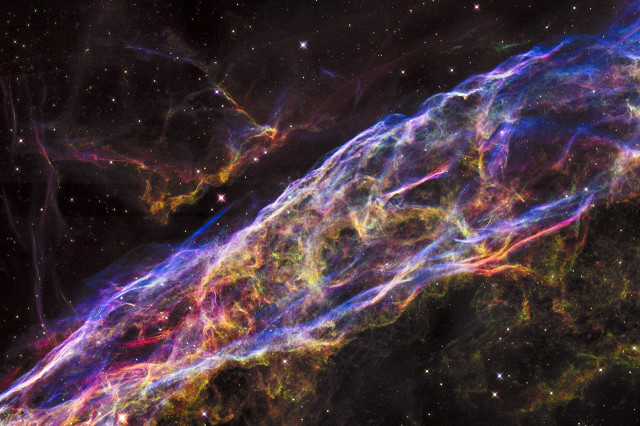 Mosaic image captured by the NASA/ESA Hubble Space Telescope shows a detailed look of the a small section of the Veil Nebula, the remains of a massive star that exploded about 8,000 years ago. (NASA, ESA, and the Hubble Heritage Team (STScI/AURA))