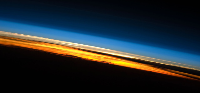 A view of Earth's atmosphere at sunset as seen by the International Space Station Expedition 23 crew in 2010. Colors here roughly denote the various layers of the atmosphere. (NASA)