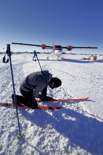 Refael Klein checks his bindings outside the Amundson-Scott South Pole Station. (Photo by Hunter Davis)