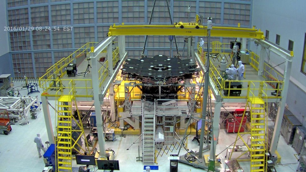 Webcam screen capture of technicians at NASA’s Goddard Space Flight Center installing the 18th and final panel of the James West Space Telescope’s 6.5 meter primary mirror on 1/29/16. (NASA/Goddard Space Flight Center)