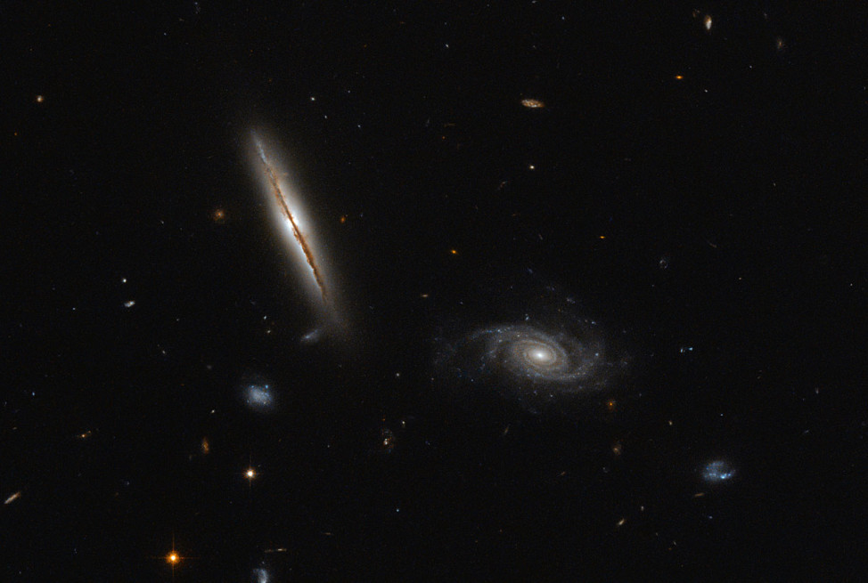 Released on 1/25/16, this is a Hubble Space Telescope image of two galaxies.  The one on the left-side is the edge of the LO95 0313-192 galaxy.  The spiral galaxy on the right-side is known as [LOY2001] J031549.8-190623. (ESA/Hubble & NASA)