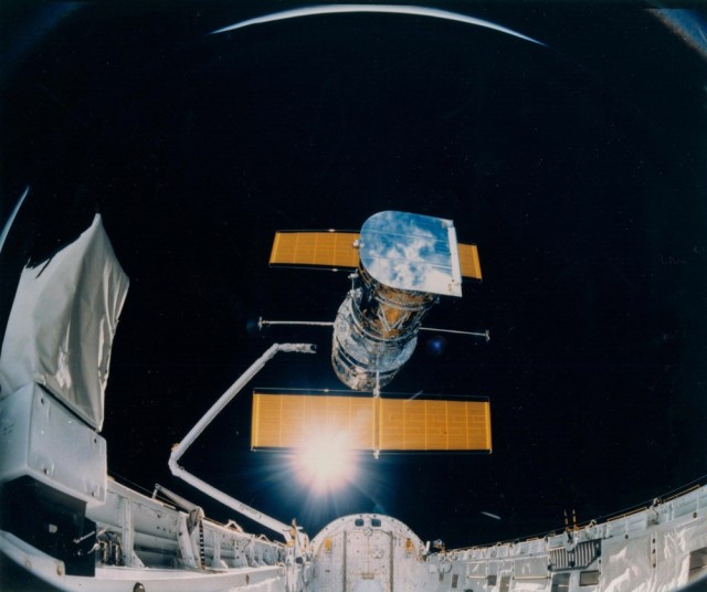 This photograph was taken by the STS-31 crew aboard the Space Shuttle Discovery and shows the Hubble Space Telescope being deployed on April 25, 1990, from the payload bay. (NASA)