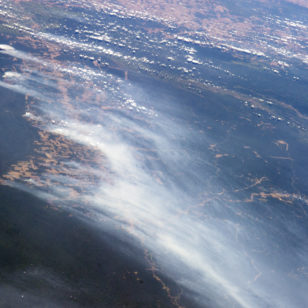 The smoke from multiple fires in the Mato Grosso region of Brazil rises over forested and deforested areas in this astronaut photograph taken from the International Space Station on August 19, 2014. International Space Station (NASA)