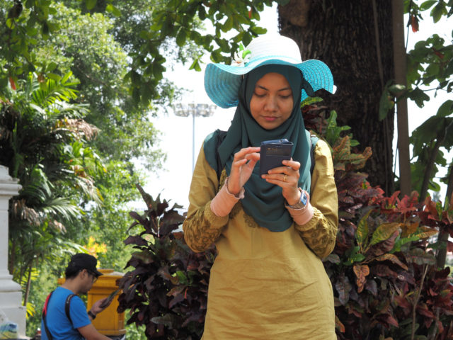 Woman checks her smartphone. (John Ragai via Creative Commons/Flickr)