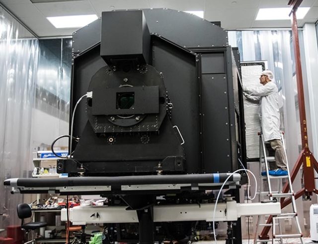Hector Rodriguez, senior mechanical technician, works on the Keck Cosmic Web Imager in a clean room at Caltech. (Caltech)