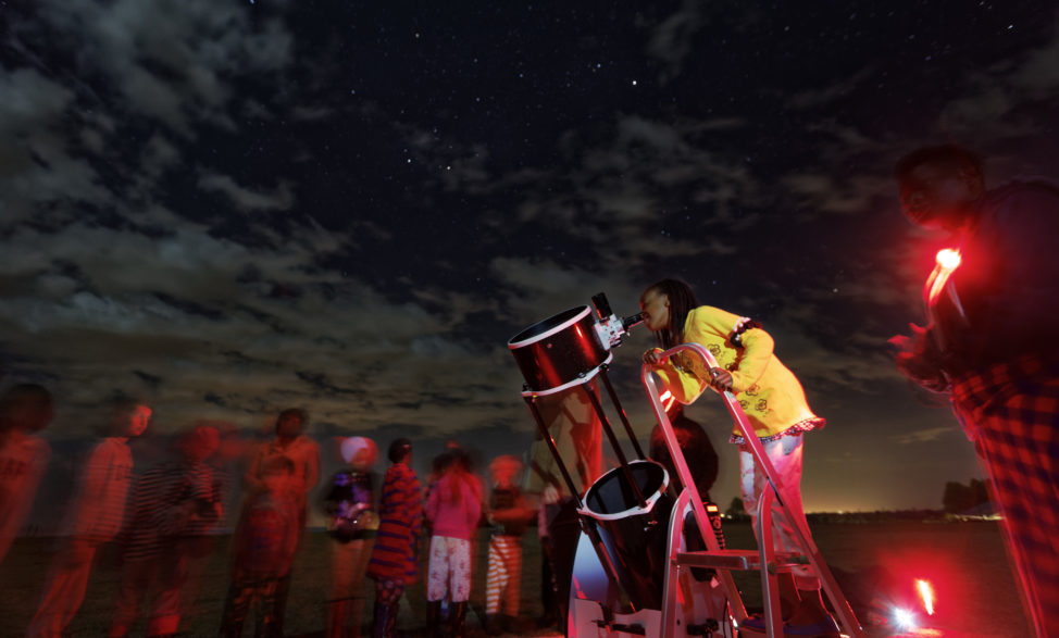 In this photo taken 2/3/17, a student looks up at the moon through a telescope, during a visit by The Traveling Telescope at St Andrew's School near Molo in Kenya's Rift Valley. The Traveling Telescope visits some of the country's most remote areas with telescopes and virtual reality goggles. (AP)