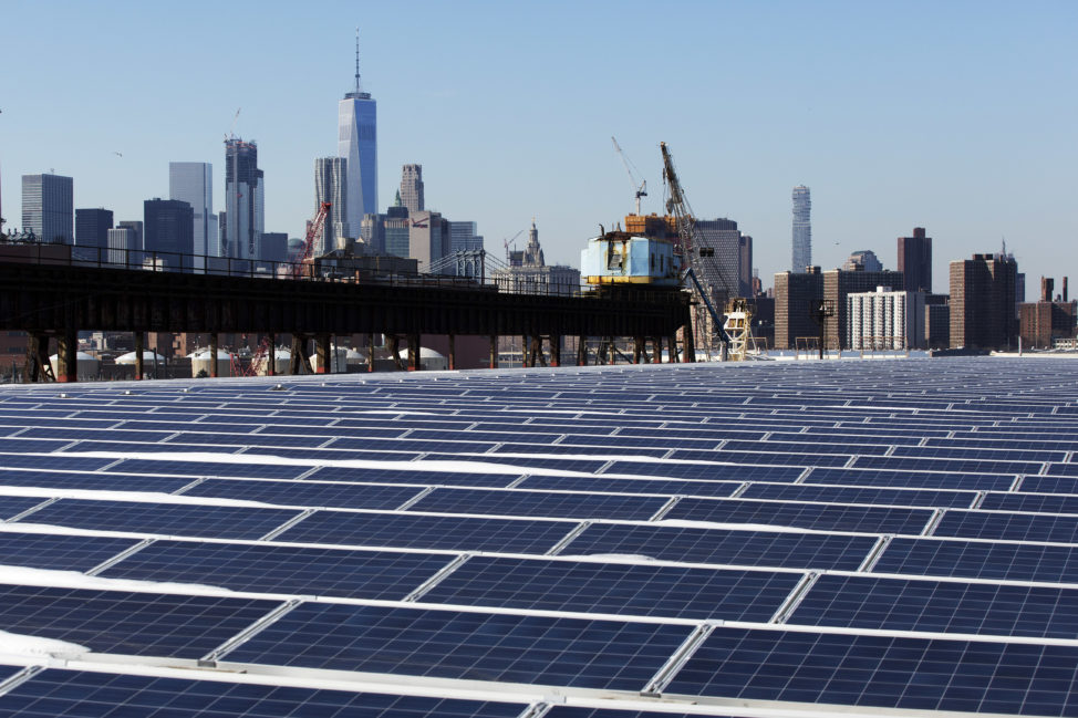 A rooftop is covered with solar panels at the Brooklyn Navy Yard, 2/14/17, in New York City, you can see the Manhattan skyline is at top. According to the New York City Mayor’s office, these new panels will generate 1.1 million kilowatt hours of energy per year. (AP)