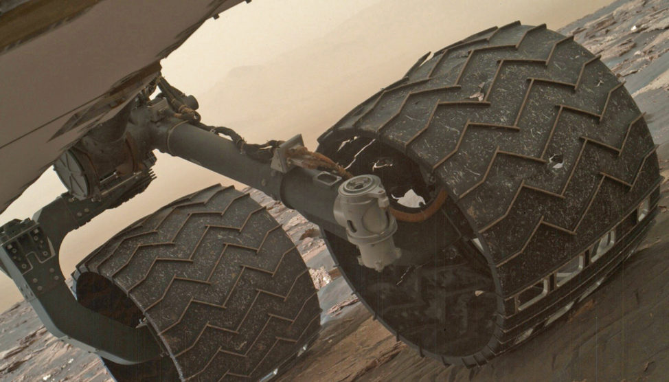 Two of the raised treads on the left middle wheel of NASA's Curiosity Mars rover broke during the first quarter of 2017. You can especially see one that’s partially detached at the top of the wheel. The photo was taken 3/19/17 with the Mars Hand Lens Imager (MAHLI) camera that’s attached to on the rover's arm. (NASA/JPL-Caltech/MSSS)