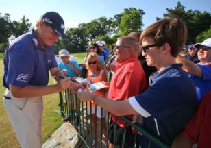 Ernie Els signs autographs after the third round of the Quicken Loans National at the Congressional Country Club in Bethesda, Maryland. (photo by Bill Workinger / Voice of America)