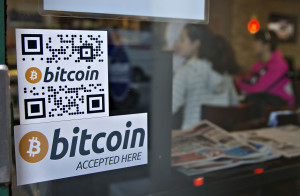 Signs on window advertise a bitcoin ATM machine in a Waves Coffee House in Vancouver, British Columbia , Canada, Oct. 28, 2013. (Reuters)