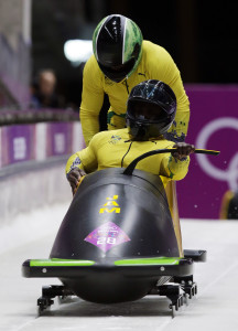 The team from Jamaica JAM-1, piloted by Winston Watts and brakeman Marvin Dixon, start their third run during the men's two-man bobsled competition at the 2014 Winter Olympics, Feb. 17, 2014, in Krasnaya Polyana, Russia. (AP)