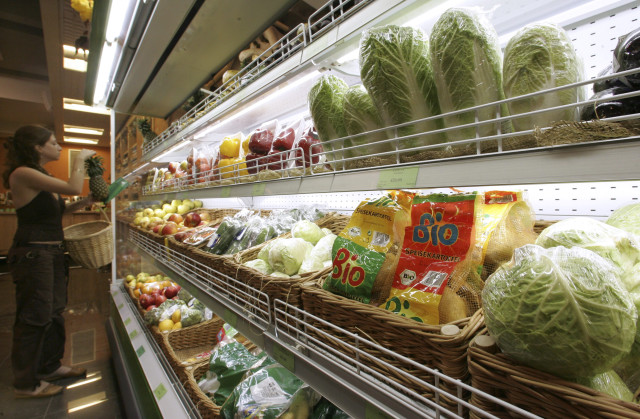 A customer stands in a supermarket as a label of GM-free food is seen in the foreground in Moscow, Russia, June 22, 2007. (Reuters)