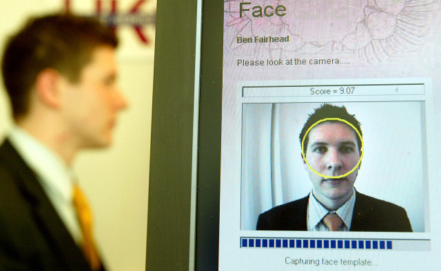 A British Passport Office volunteer has his face scanned for a biometrics enrollment card in London, April 26, 2004. (Reuters)