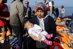 An Afghan refugee holds her three-month-old baby girl Zainab after arriving at a beach on the Greek island of Lesbos after crossing a part of the Aegean sea from Turkey Sept. 17, 2015. (Reuters)