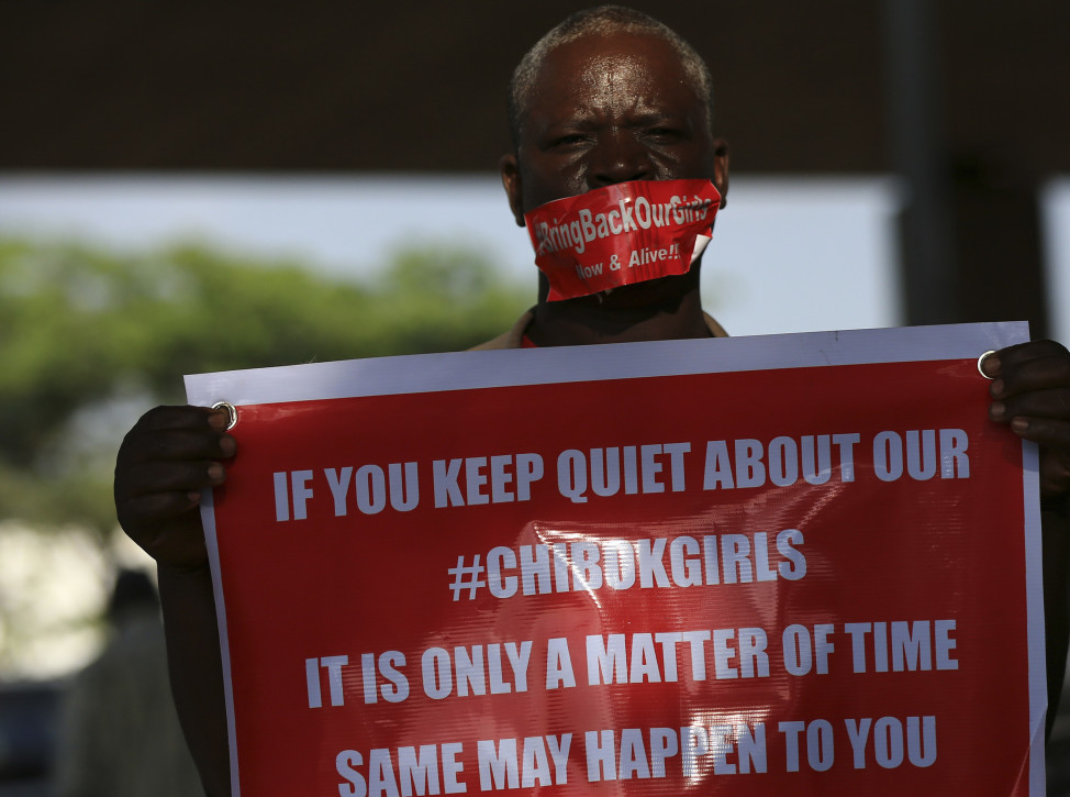 A member of the #BringBackOurGirls campaign group holds a placard featuring another related hashtag on the 140th day of the abduction of 219 schoolgirls from Government Secondary School in Chibok, Borno State. The girls were abducted while they were sitting for their final exams, Abuja, Sept. 1, 2014. (Reuters)