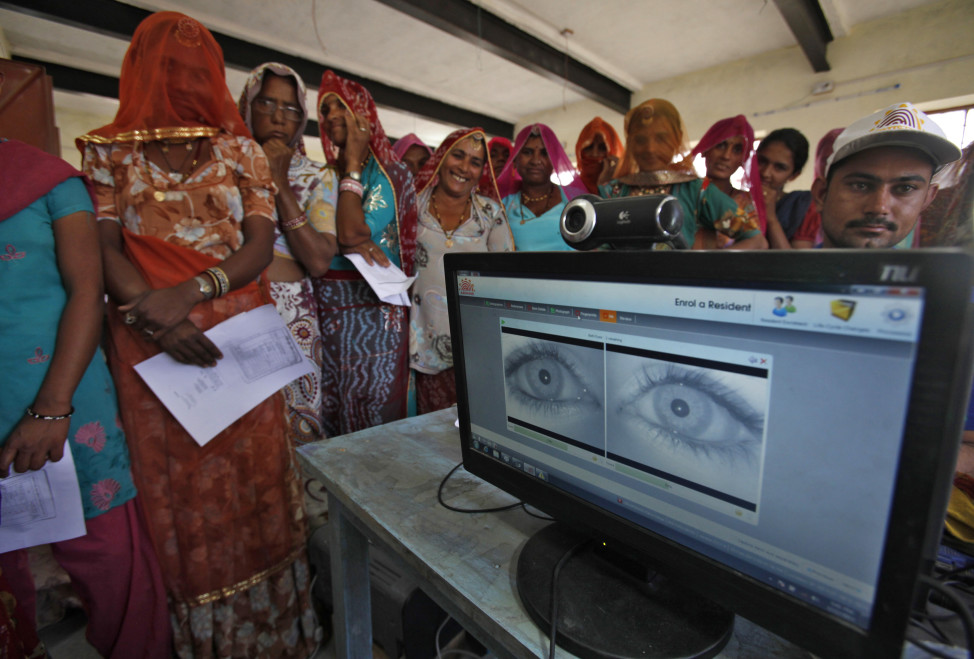 FILE - Village women stand in a queue to get themselves enrolled for the Unique Identification (UID) database system at Merta district in the desert Indian state of Rajasthan. The Indian government has been using the UID database, known as Aadhaar, to make direct cash transfers to the poor.