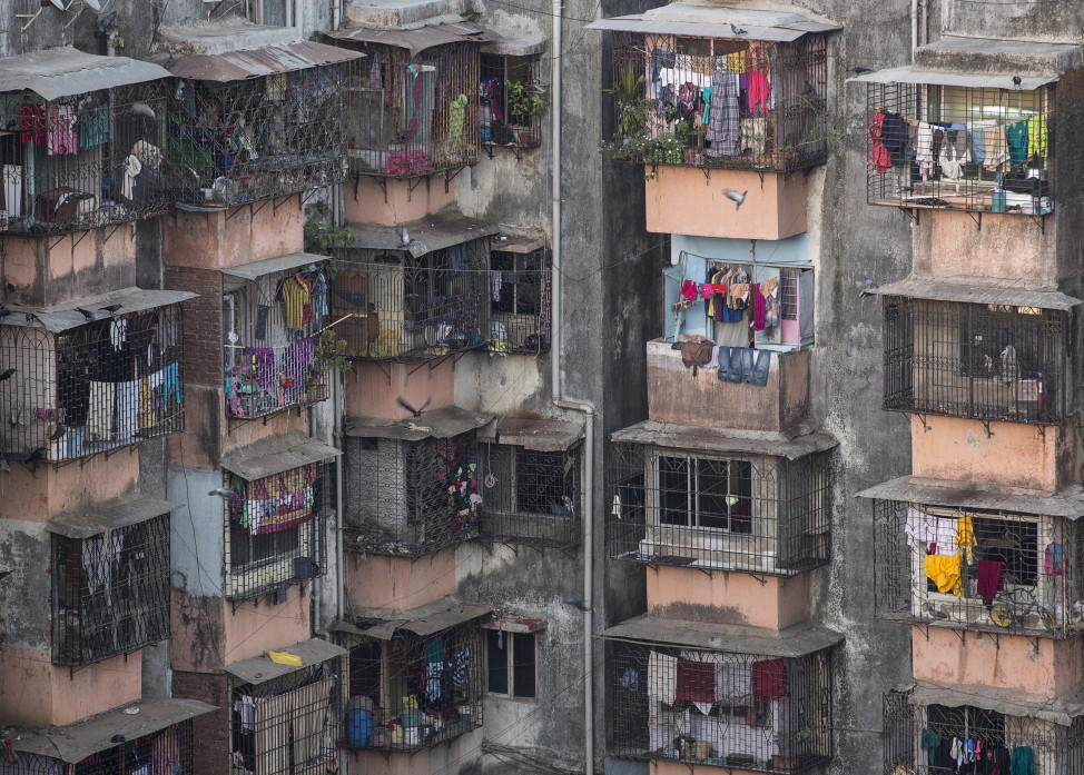 FILE - Windows of various apartments of a residential building are seen in Dharavi, one of Asia's largest slums, in Mumbai, March 18, 2015. (Reuters)