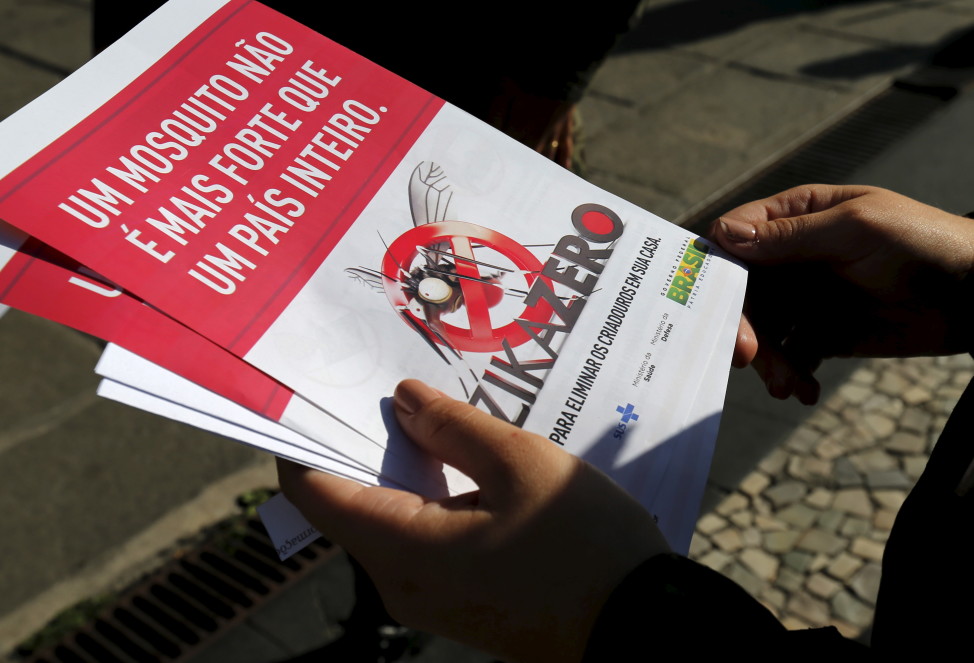 A Brazilian Army soldier shows pamphlets during the National Day of Mobilization Zika Zero in Rio de Janeiro, Brazil, Feb. 13, 2016. The pamphlet reads, 'A mosquito is not stronger than an entire country.' (Reuters)