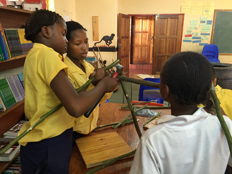 Girls in the 'Design Squad Global Club' at SOS Children’s Village school in Mbabane, Swaziland build a waste bin to reduce litter around their school. (WGBH Educational Foundation)