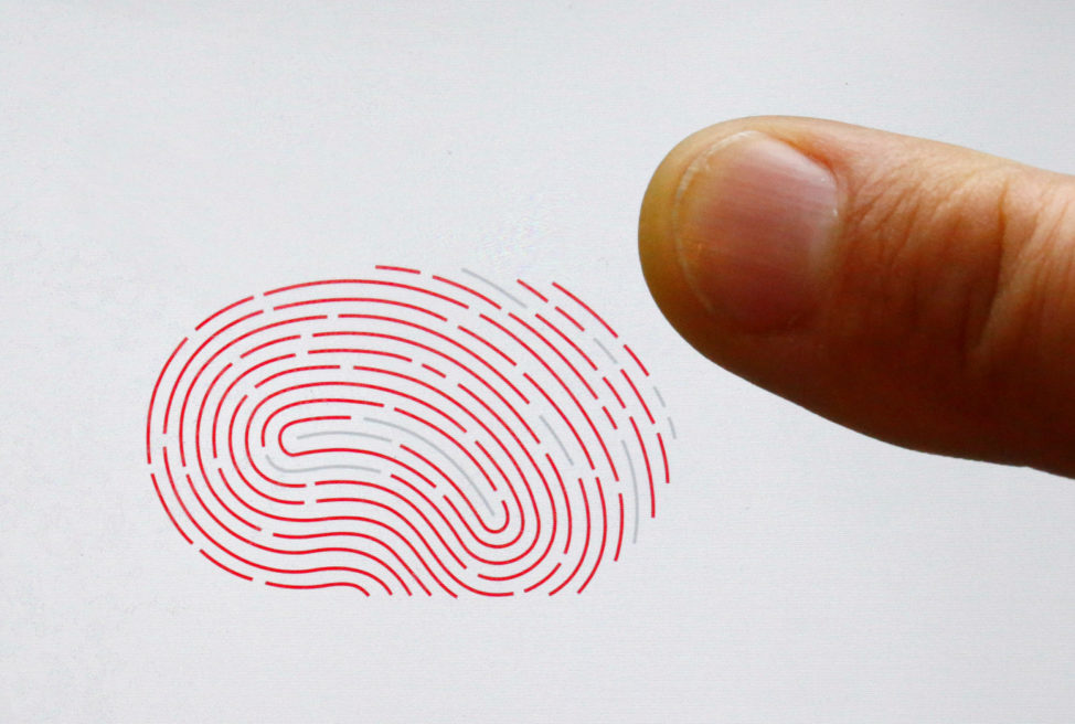 FILE - A person uses a sensor for biometric identification on a smartphone in Berlin, Germany Oct. 16, 2015. 