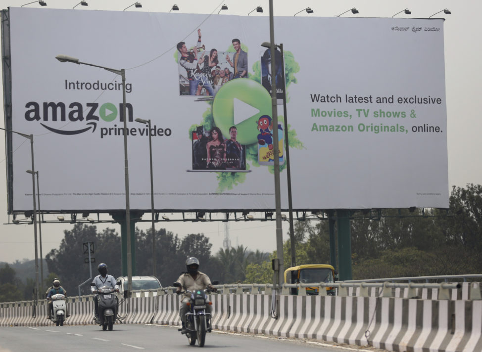 Motorists ride past an advertising for an Amazon product in Bangalore, India, Jan. 12, 2017. 