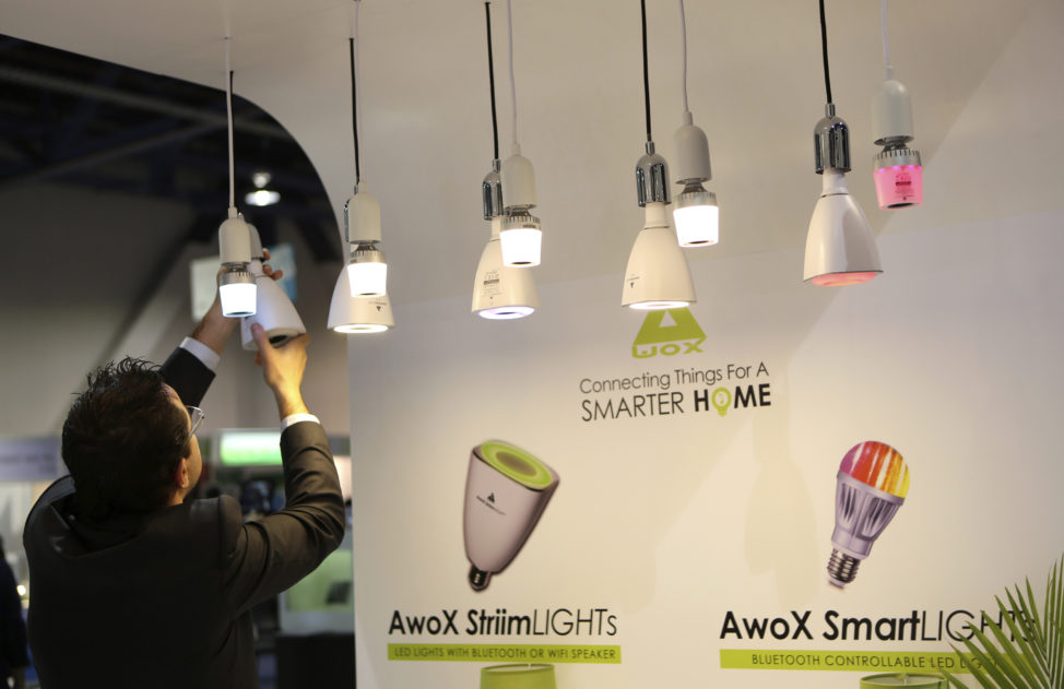 FILE - A man changes a bulb in Awox Smart Lights, which features a Bluetooth controllable LED light, in Las Vegas, Nevada. (Reuters)