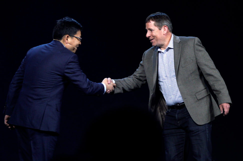 Steve Rabuchin, Amazon president of Amazon Alexa (R) shakes hands with Richard Yu, CEO of Huawei Consumer Business Group during the Huawei keynote address at CES in Las Vegas, Jan. 5, 2017. 