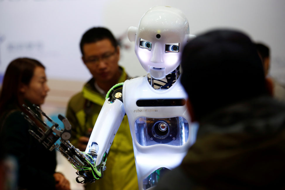 FILE: People look at a RoboThespian humanoid robot at the Tami Intelligence Technology stall at the WRC 2016 World Robot Conference in Beijing, China, Oct. 21, 2016. 