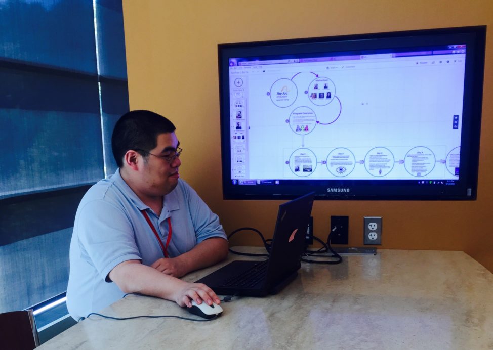 Jeff Wang, a SAP employee participating in the Autism at Work training program, learns how to use presentation tool Prezi and shares an overview of what he learned in training with a room full of managers. (SAP)