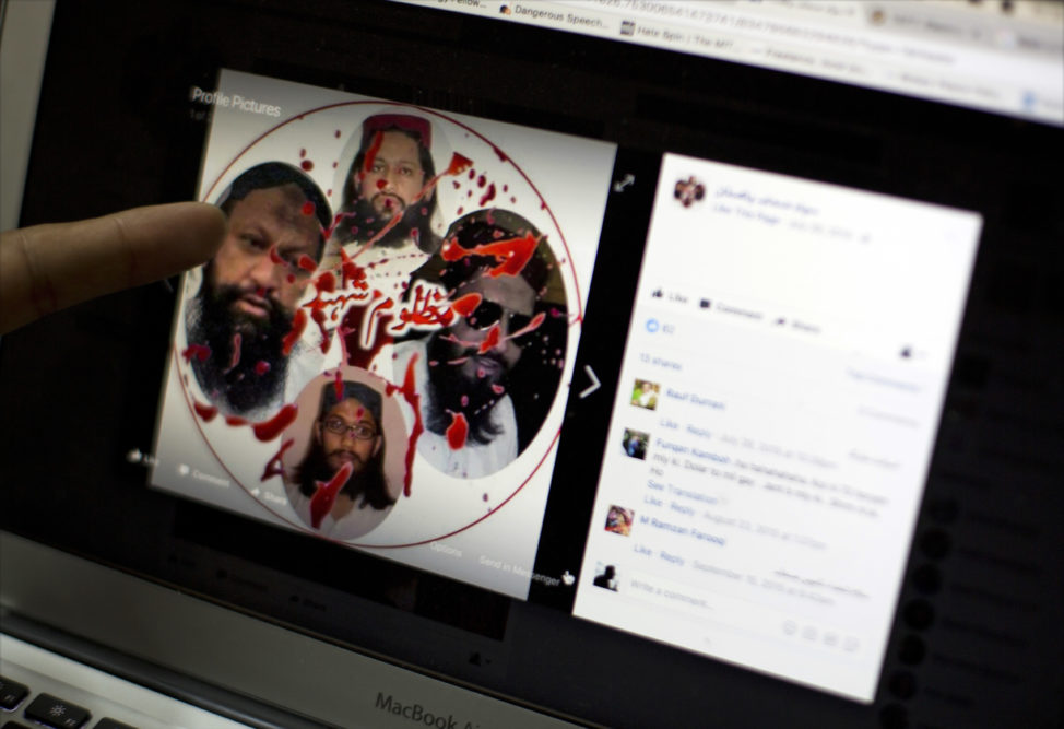 FILE - A social media rights activist points to a Facebook page of a militant group featuring their late leaders, describing them as, "innocent martyrs," in Islamabad, Pakistan, July 7, 2017. (AP)