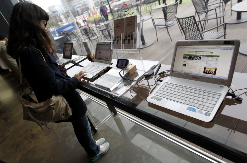 FILE - A woman surfs the Internet on a computer for visitors in Seoul, South Korea. (Reuters) 