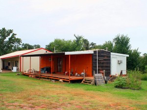 Talk about creative.  A combination house trailer and railroad car made into a double-wide! (Chuck “Caveman” Coker, Flickr Creative Commons)