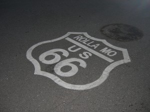 We associate historic U.S. Route 66 with the American heartland.  And the nation's population mean center is already past this pavement sign near Rolla, Missouri.  (jimmywayne, Flickr Creative Commons)