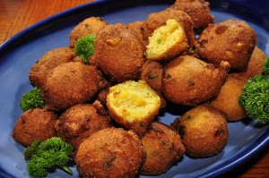 A yummy plate of hushpuppies.  The term for these cornmeal treats is said to trace to a time when the family dog begged for something and was told, "Hush, puppy!"  (jeffreyw, Flickr Creative Commons)
