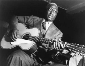 Lead Belly (his preferred spelling) was a 12-string guitar virtuoso as well as a powerful blues and folk singer.  (Wikipedia Commons)