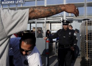 Security has been ramped up at L.A. Dodgers' games ever since the savage beating of a fan for merely wearing the opposing team's jersey.  (AP Photo/Jae C. Hong)