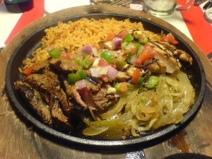 A fajita, this one containing chicken as well as steak, in the making.  (Elisa Arteaga, Flickr Creative Commons)