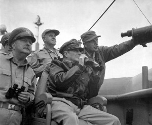 General MacArthur, raising binoculars to his eyes, observes the shelling of Inchon from a U.S. battleship. (U.S. Army)