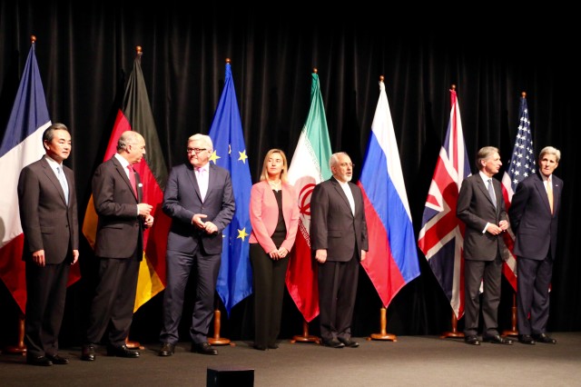 Delegation leaders from P5+1 nations, the EU and Iran assemble to announce deal to limit Iran's nuclear weapons program in Vienna July 14. From left, China's Foreign Minister Wang Yi, France's Foreign Minister Laurent Fabius, Germany's Foreign Minsiter Frank-Walter Steinmeier, EU High Representative for Foreign Affairs Federica Mogherini, Iran's Foreign Minister Javad Zarif, UK Foreign Minister Philip Hammond, U.S. Secretary of State John Kerry. (VOA/Brian Allen)