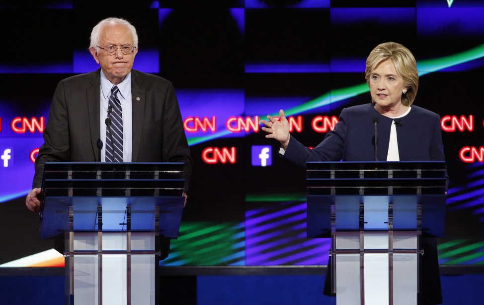 Hillary Rodham Clinton, right, speaks as Sen. Bernie Sanders, I-Vt., listens during the CNN Democratic presidential debate Tuesday, Oct. 13, 2015, in Las Vegas.(AP)