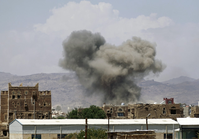 Smoke billows from buildings after reported air strikes by the Saudi-led coalition on arms warehouses at Al-Dailami air base, on September 29, 2015, north of the capital Sanaa. (AFP)